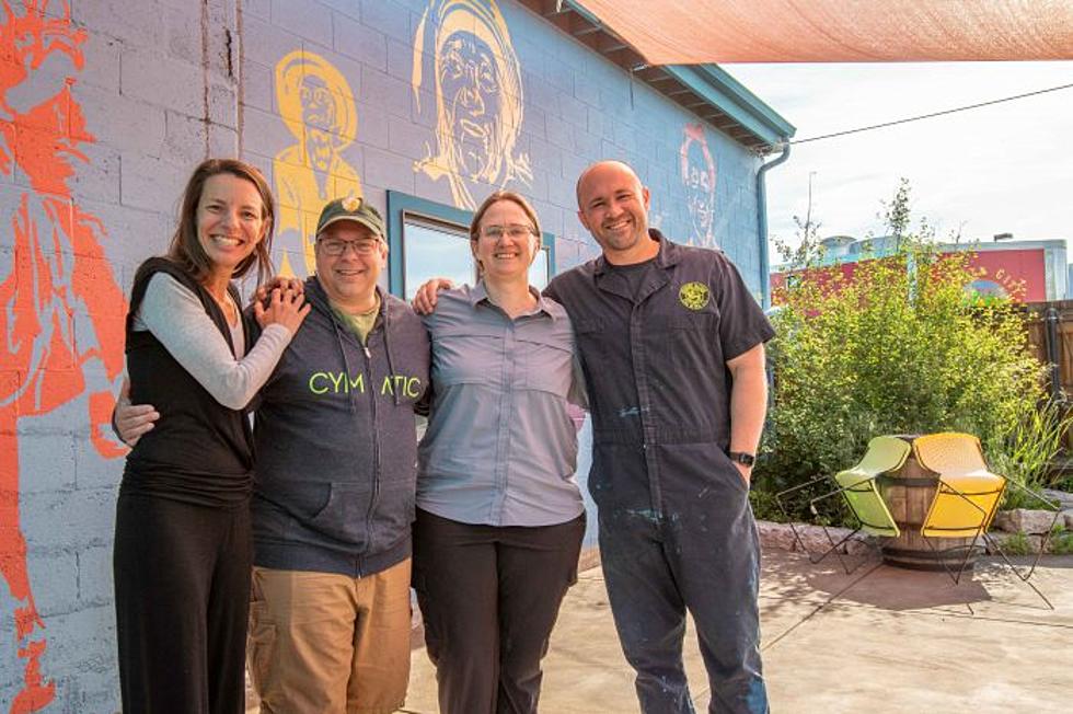 Current Imagine Nation Brewing owners Fernanada and Robert on either side of Cymatic Owner/New Imagine Nation Brewing owners Tim and Annie Graham